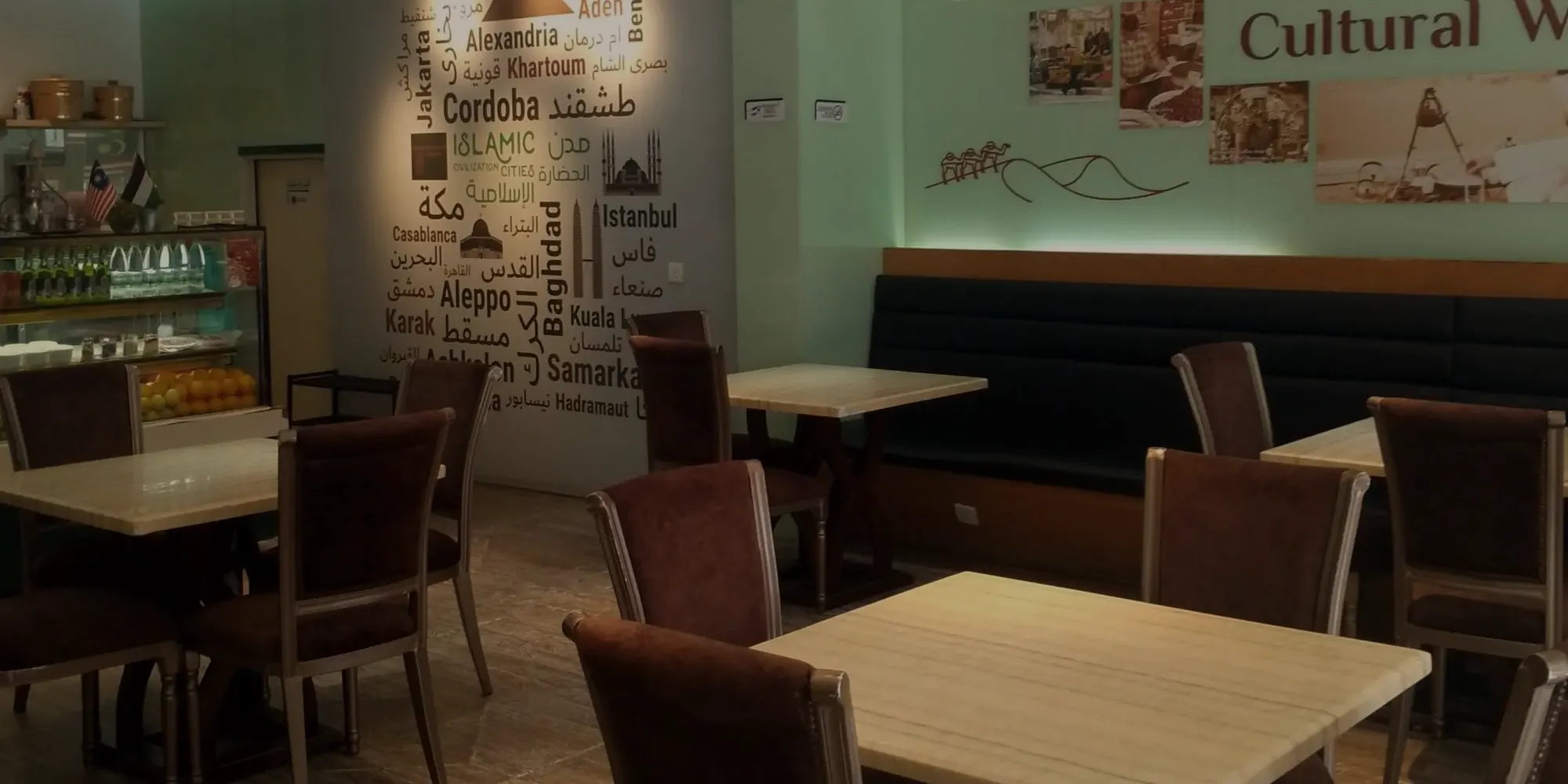 The dining room, with a wall of city names behind the tables